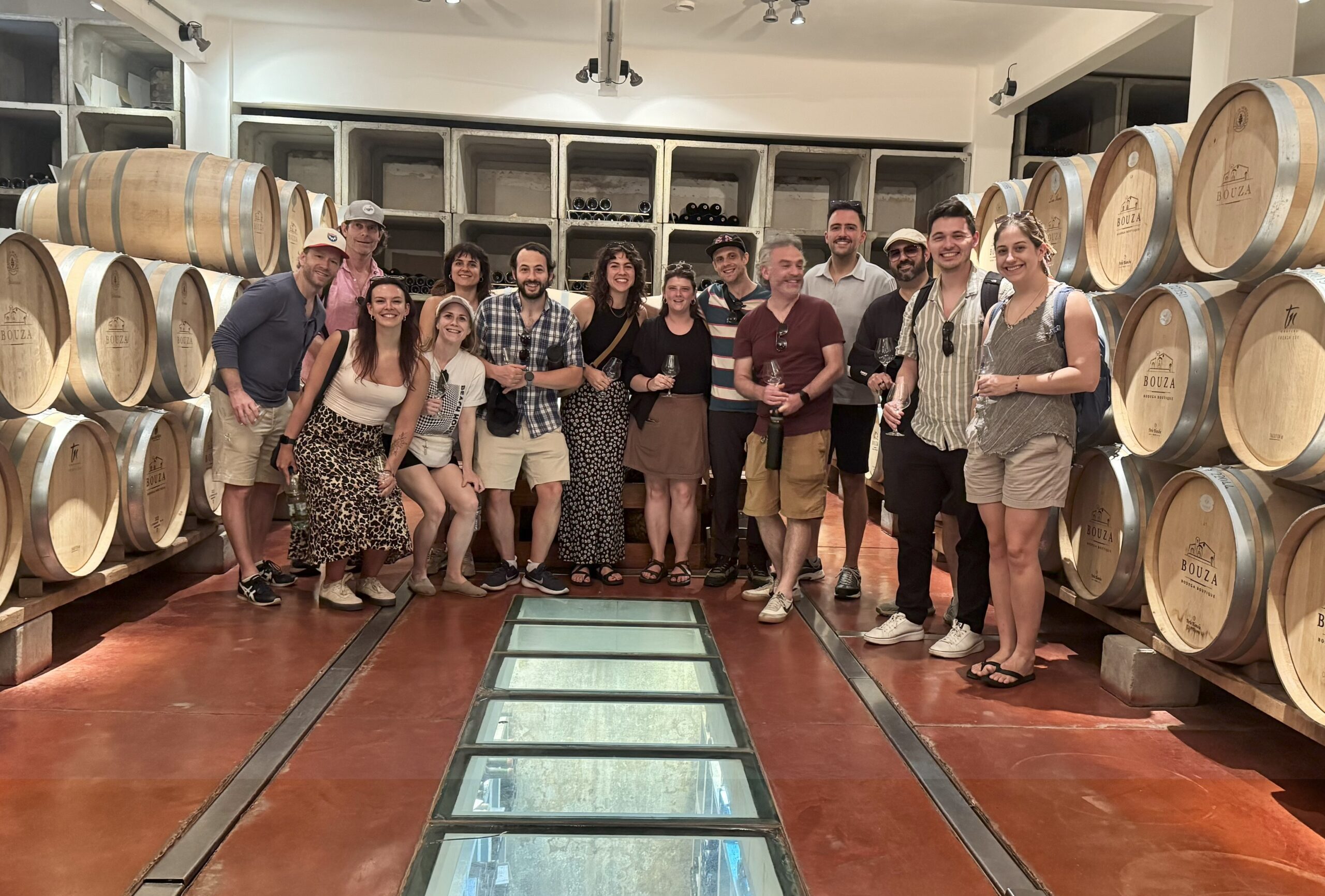 Group photo among the barrels of a Uruguayan winery